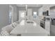 Bright kitchen featuring white cabinets, stainless steel appliances, and a large island with seating at 46 N Denny St, Indianapolis, IN 46201