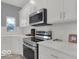 Stylish kitchen with white cabinets, stainless steel appliances, and modern finishes at 46 N Denny St, Indianapolis, IN 46201