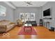 Bright living room with hardwood floors, large windows, and a stylish red rug at 46 N Denny St, Indianapolis, IN 46201