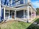 Inviting covered porch with sturdy white columns, dark blue siding, and well-maintained green lawn at 46 N Denny St, Indianapolis, IN 46201