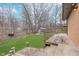 Spacious backyard featuring a wooden deck, brick pathway, a storage shed, and mature trees at 516 Hanover Dr, Anderson, IN 46012