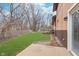 Large backyard featuring a lush, green lawn, mature trees, and a wooden shed at 516 Hanover Dr, Anderson, IN 46012