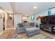 Comfortable basement rec room with plush gray sofa, modern TV, and neutral decor at 516 Hanover Dr, Anderson, IN 46012