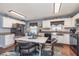 Charming eat-in kitchen features white cabinets, stainless appliances, and trendy backsplash at 516 Hanover Dr, Anderson, IN 46012