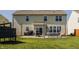 Expansive backyard featuring a large patio area, outdoor seating, and well-maintained lawn at 5387 Crowley Pkwy, Whitestown, IN 46075