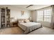 Cozy bedroom with neutral tones, a large window, bookshelf, and comfortable furnishings for a serene retreat at 5387 Crowley Pkwy, Whitestown, IN 46075