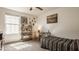 Bright bedroom featuring a large window, desk, shelving, and a comfortable bed with striped bedding at 5387 Crowley Pkwy, Whitestown, IN 46075