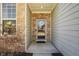 Inviting front entryway with brick accents, stylish door with wreath, and neutral siding at 5387 Crowley Pkwy, Whitestown, IN 46075