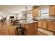 Open concept kitchen with modern appliances, granite counters, wood cabinets and a dining area at 5387 Crowley Pkwy, Whitestown, IN 46075