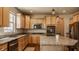 Bright kitchen with stainless appliances, granite counters, wood cabinets and a center island at 5387 Crowley Pkwy, Whitestown, IN 46075
