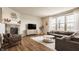 Cozy living room features a stone fireplace, stylish decor, and ample natural light at 5387 Crowley Pkwy, Whitestown, IN 46075