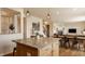 Open floor plan features a bright kitchen with island that opens up to a cozy living room with fireplace at 5387 Crowley Pkwy, Whitestown, IN 46075
