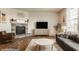 Well-lit living room showcasing a stone fireplace, stylish furniture, and warm ambiance at 5387 Crowley Pkwy, Whitestown, IN 46075