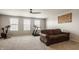Recreation room featuring a comfortable sofa, treadmill, exercise bike, and natural light from windows at 5387 Crowley Pkwy, Whitestown, IN 46075