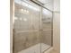 Shower with sliding glass door, tile surround, and built-in shelving offers a spa-like experience at 5387 Crowley Pkwy, Whitestown, IN 46075