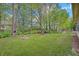 Backyard with lush green grass, play set, and fire pit at 5541 Fair Ridge Pl, Indianapolis, IN 46221