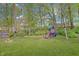 Expansive backyard with a fire pit and playset, perfect for outdoor fun at 5541 Fair Ridge Pl, Indianapolis, IN 46221