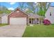Charming brick home featuring a two-car garage, a cozy front porch, and a well-maintained lawn at 5541 Fair Ridge Pl, Indianapolis, IN 46221