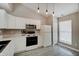 Bright kitchen featuring white cabinets, modern appliances, and pendant lighting at 5541 Fair Ridge Pl, Indianapolis, IN 46221