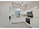 Clean kitchen featuring white cabinets, modern appliances, and ample counter space at 5541 Fair Ridge Pl, Indianapolis, IN 46221