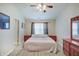 Comfortable main bedroom features modern flooring, neutral walls, ceiling fan, and a window at 5541 Fair Ridge Pl, Indianapolis, IN 46221
