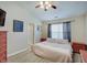 Comfortable main bedroom features modern flooring, neutral walls, ceiling fan, and a window at 5541 Fair Ridge Pl, Indianapolis, IN 46221