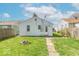 Backyard showing detached garage, lawn, walkway, and partial fencing at 555 Leeds Ave, Indianapolis, IN 46203
