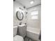 Updated bathroom features tub, shower, gray vanity, and brushed nickel fixtures at 555 Leeds Ave, Indianapolis, IN 46203