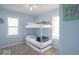 Light blue bedroom contains a bunk bed and two windows at 555 Leeds Ave, Indianapolis, IN 46203