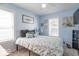 Light blue bedroom with carpet, two windows, a queen size bed, and decorative items at 555 Leeds Ave, Indianapolis, IN 46203