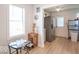 Dining area with wood floors, view to the kitchen, and ample natural light at 555 Leeds Ave, Indianapolis, IN 46203
