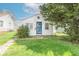 Charming home with a quaint front yard and blue door, under a sunny sky at 555 Leeds Ave, Indianapolis, IN 46203