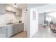 Modern kitchen with gray cabinets and view into the bright living room at 555 Leeds Ave, Indianapolis, IN 46203