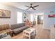 Bright living room with modern ceiling fan, updated floors and neutral walls at 555 Leeds Ave, Indianapolis, IN 46203