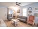 Bright living room with modern ceiling fan, updated floors and neutral walls at 555 Leeds Ave, Indianapolis, IN 46203
