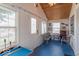 Cozy sun room with multiple windows, blue floor, and small pool table at 555 Leeds Ave, Indianapolis, IN 46203