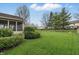Beautiful backyard featuring a well-maintained lawn, mature trees, and a cozy screened-in porch at 5710 Dapple Trce, Indianapolis, IN 46228
