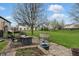 Spacious backyard with patio, seating, and a blooming tree, perfect for outdoor enjoyment at 5710 Dapple Trce, Indianapolis, IN 46228