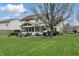 Spacious backyard featuring a screened-in porch, patio, and grill area, perfect for outdoor entertaining at 5710 Dapple Trce, Indianapolis, IN 46228