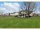 Expansive green backyard with a screened porch and grill area, great for relaxation and outdoor activities at 5710 Dapple Trce, Indianapolis, IN 46228