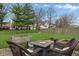 Inviting backyard featuring a fire pit, comfortable seating, and ample green space for recreation at 5710 Dapple Trce, Indianapolis, IN 46228