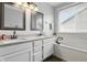 Bright bathroom featuring a soaking tub, double vanity, granite counters, and natural light from a window at 5710 Dapple Trce, Indianapolis, IN 46228