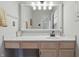 Bright bathroom featuring a large mirror, vanity with drawers, and modern light fixture at 5710 Dapple Trce, Indianapolis, IN 46228