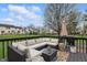 Expansive deck with comfortable sectional seating, outdoor rug, and lush spring landscaping at 5710 Dapple Trce, Indianapolis, IN 46228