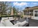 Inviting outdoor deck area with plush sectional seating, umbrella, and views of a landscaped yard at 5710 Dapple Trce, Indianapolis, IN 46228
