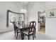 Dining room with hardwood table, upholstered chairs, chandelier, and large window with decorative valance at 5710 Dapple Trce, Indianapolis, IN 46228