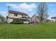 Expansive backyard view of home exterior with large yard, patio, and beautiful screened-in porch at 5710 Dapple Trce, Indianapolis, IN 46228