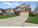 Traditional two-story home boasting a well-kept lawn, attached garage, and a wide concrete driveway at 5710 Dapple Trce, Indianapolis, IN 46228