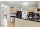 Kitchen featuring stone countertops, black appliances, and seamless access to other rooms at 5710 Dapple Trce, Indianapolis, IN 46228