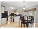 Open concept kitchen with modern appliances, dining area, and ample counter space, perfect for cooking at 5710 Dapple Trce, Indianapolis, IN 46228